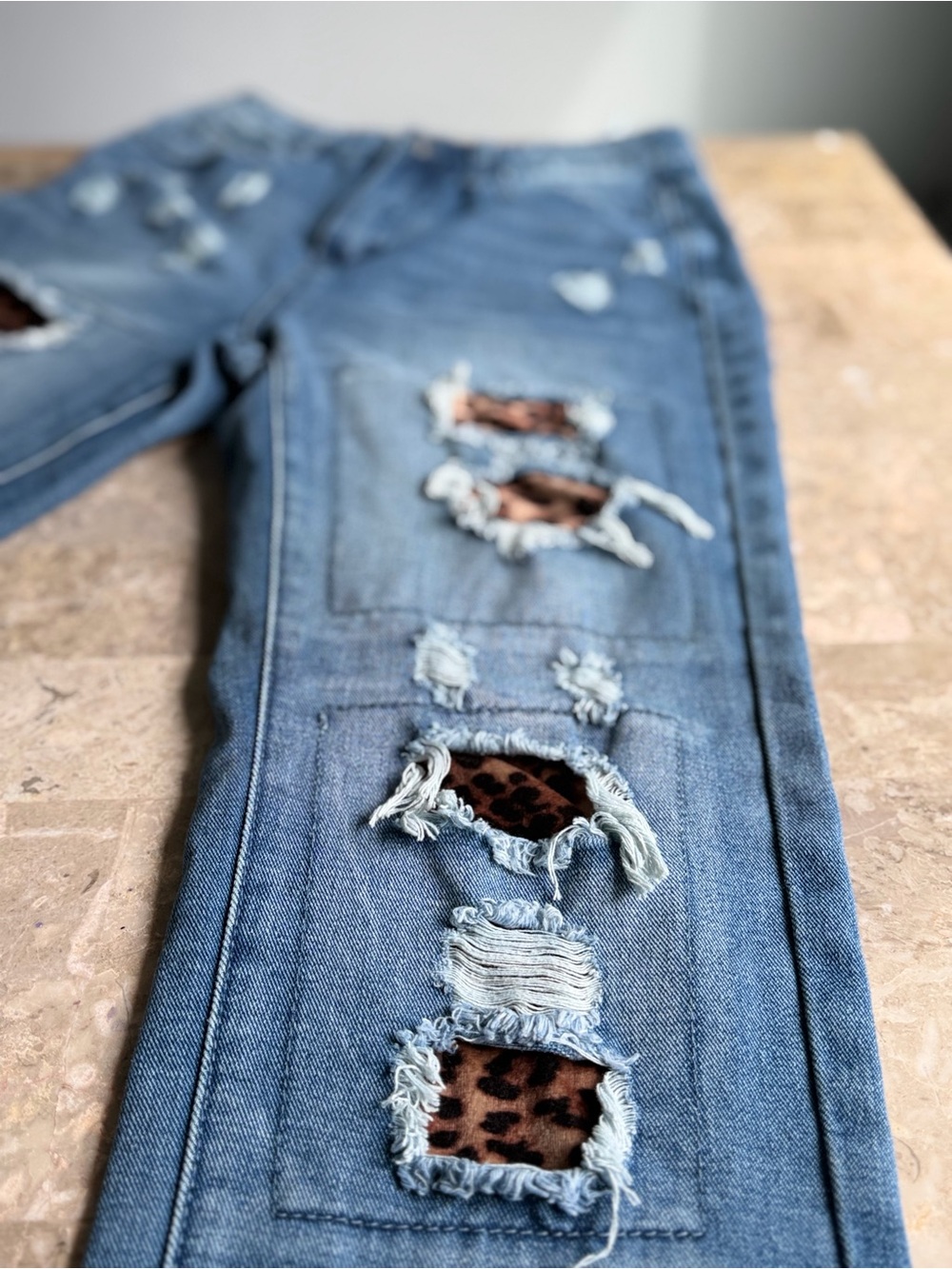 Women’s size 28 distressed boyfriend jeans. Leopard print patch ripped cuffed.